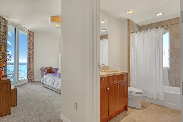 full bathroom featuring shower / tub combo, a wealth of natural light, vanity, and toilet