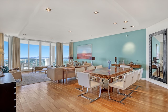 dining room with light hardwood / wood-style floors and expansive windows