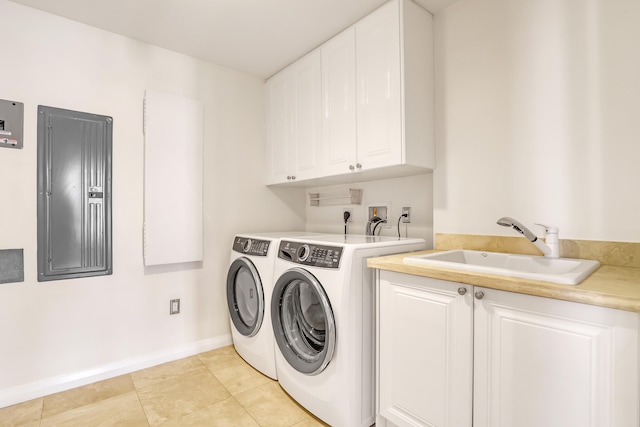 laundry room featuring electric panel, light tile patterned floors, sink, washing machine and clothes dryer, and cabinets