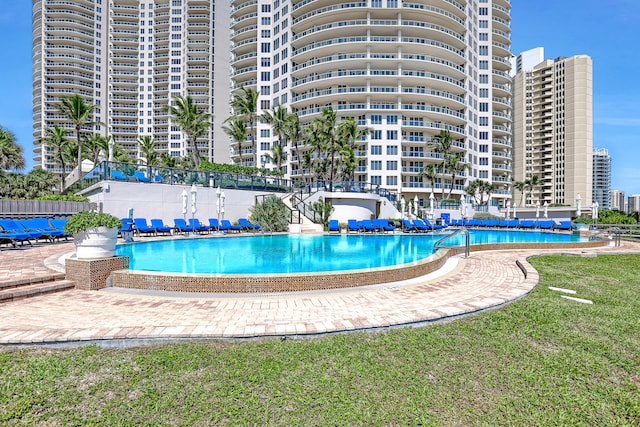 view of pool featuring a lawn