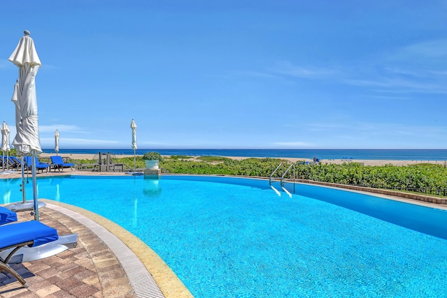 view of swimming pool featuring a water view