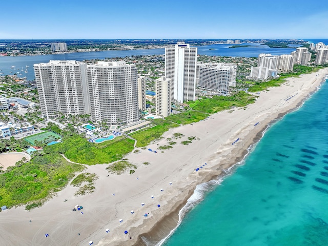 birds eye view of property featuring a water view and a beach view