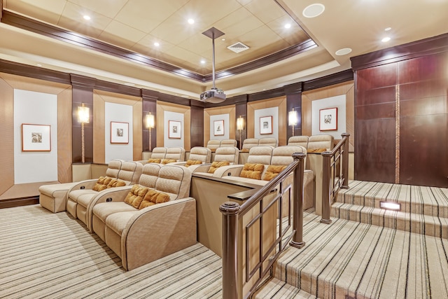 home theater with a raised ceiling and light carpet