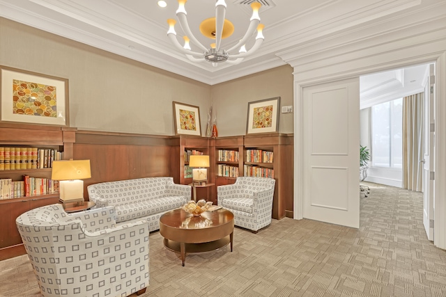 living area with an inviting chandelier and crown molding