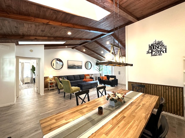 dining area featuring wooden ceiling, hardwood / wood-style floors, and lofted ceiling with beams