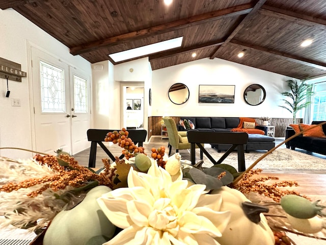 living room with wooden ceiling, hardwood / wood-style flooring, and lofted ceiling with skylight