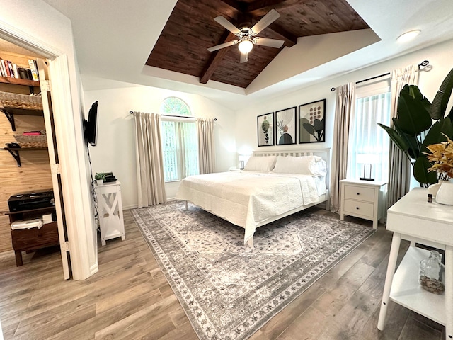 bedroom with wooden ceiling, hardwood / wood-style flooring, vaulted ceiling with beams, and ceiling fan