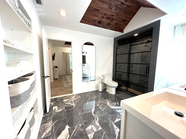 bathroom with walk in shower, toilet, wood-type flooring, lofted ceiling, and vanity