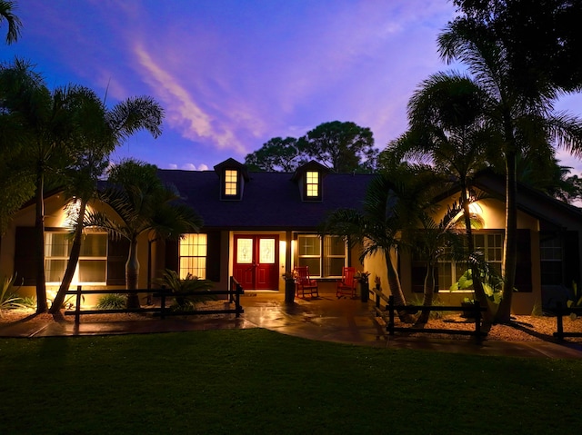 view of front facade with a lawn and a patio area