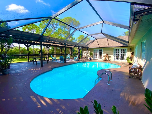 view of swimming pool with french doors, a patio area, and a lanai