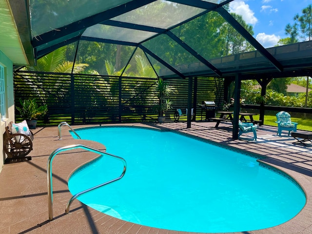 view of pool with a lanai and a patio