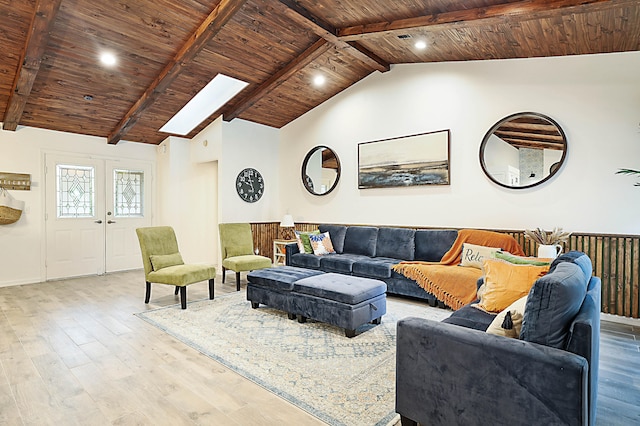 living room with vaulted ceiling with skylight, wood ceiling, and hardwood / wood-style flooring