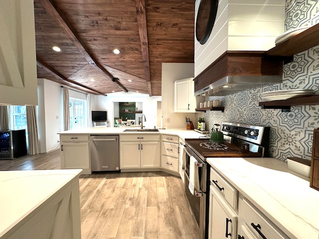 kitchen with light wood-type flooring, wood ceiling, appliances with stainless steel finishes, vaulted ceiling with beams, and white cabinetry