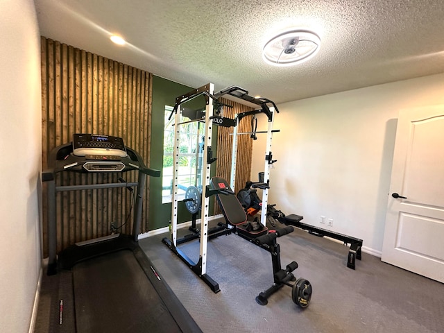 workout room featuring a textured ceiling