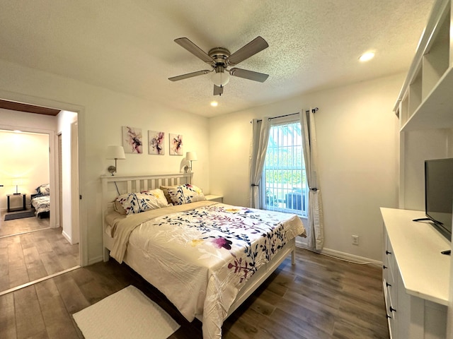 bedroom with dark hardwood / wood-style flooring, a textured ceiling, and ceiling fan