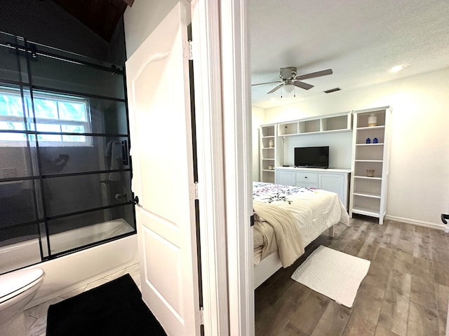 bedroom with hardwood / wood-style flooring, ceiling fan, and a textured ceiling