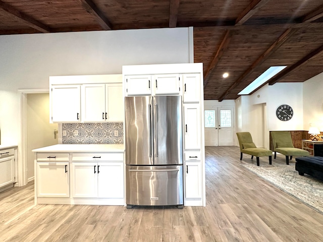 kitchen with light wood-type flooring, high end fridge, white cabinetry, and wood ceiling