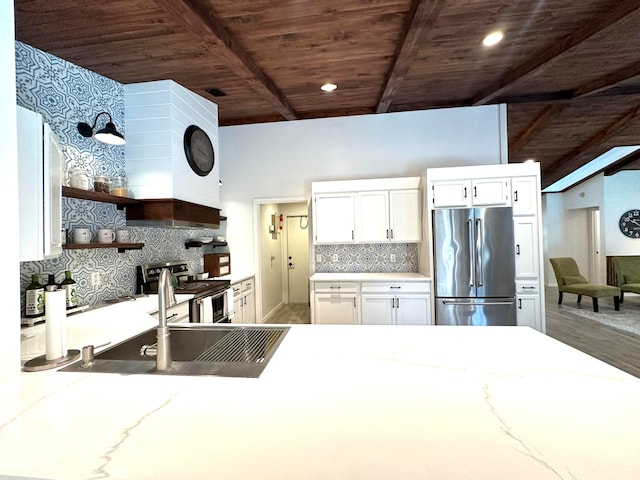 kitchen with light stone countertops, wood ceiling, stainless steel appliances, tasteful backsplash, and white cabinetry