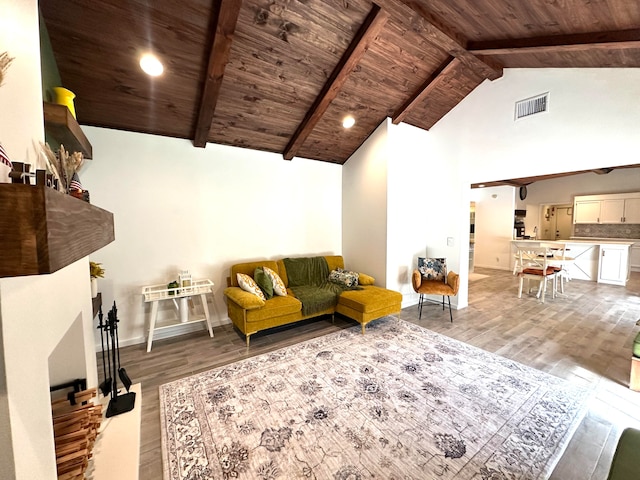 living room with high vaulted ceiling, beamed ceiling, wood ceiling, and light hardwood / wood-style floors