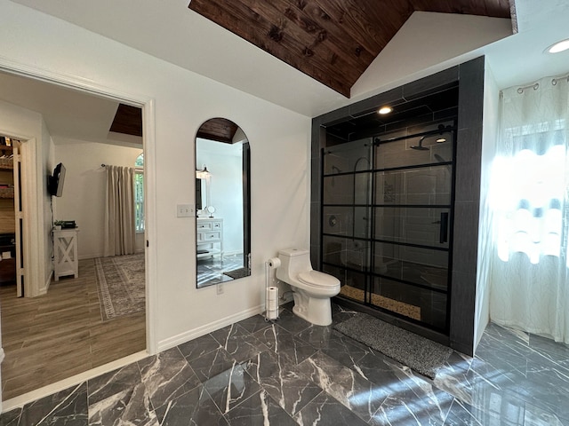 bathroom featuring plenty of natural light, toilet, vaulted ceiling, and a shower with shower door