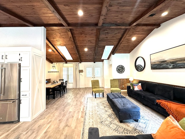 living room featuring vaulted ceiling with skylight, wood ceiling, and light hardwood / wood-style flooring