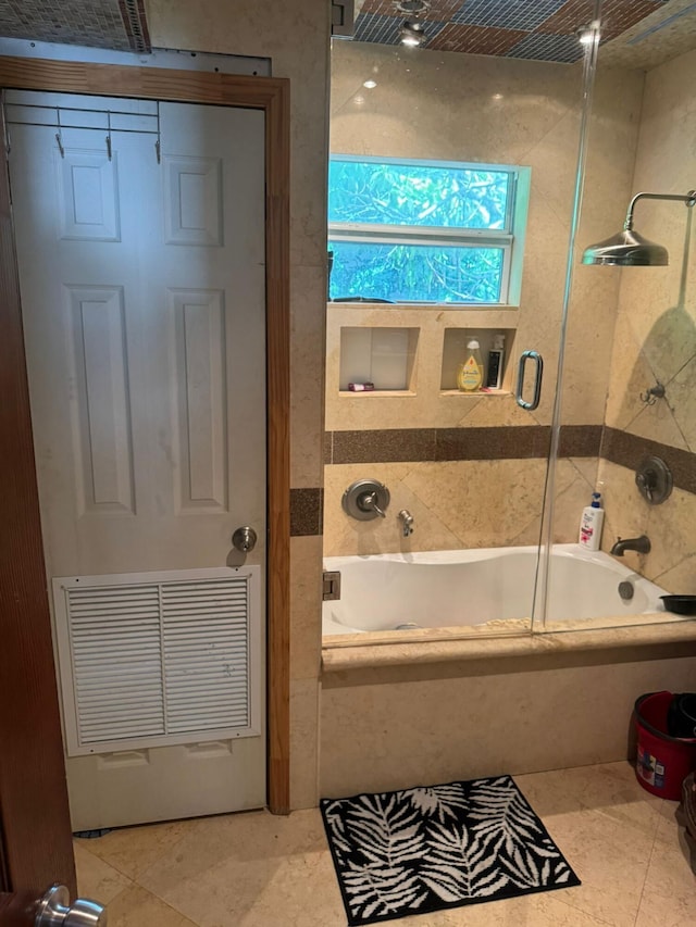 bathroom with tile patterned flooring and tiled shower / bath