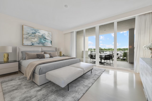 bedroom featuring floor to ceiling windows and access to exterior