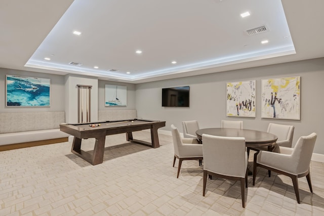 recreation room featuring light hardwood / wood-style floors, a tray ceiling, and pool table