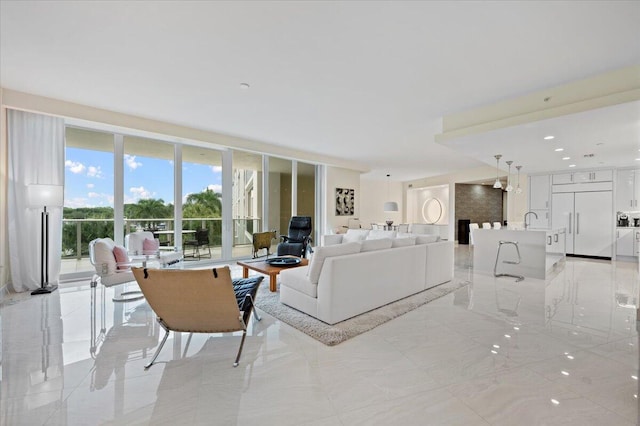 living room featuring expansive windows and sink