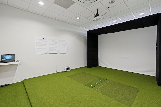 game room with carpet floors, a drop ceiling, and golf simulator