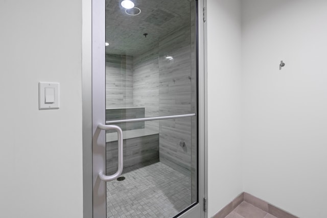 bathroom with tile patterned flooring and an enclosed shower