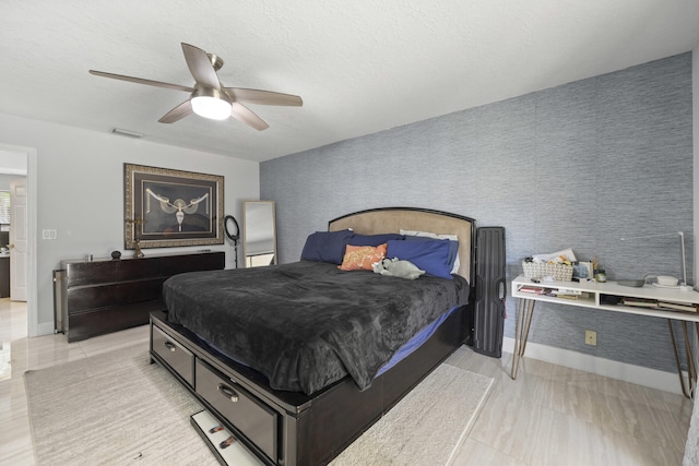 bedroom with a textured ceiling and ceiling fan