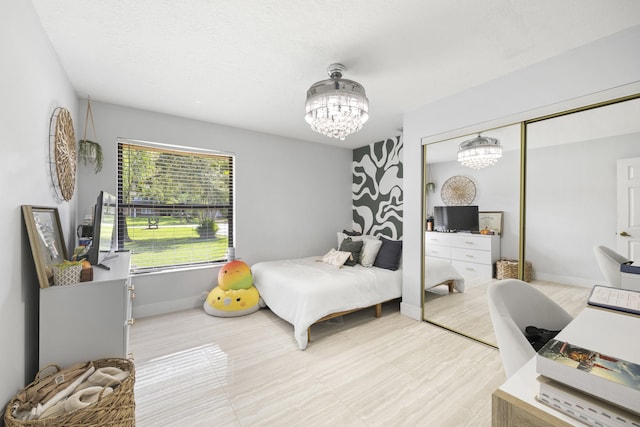 bedroom featuring a chandelier and a closet