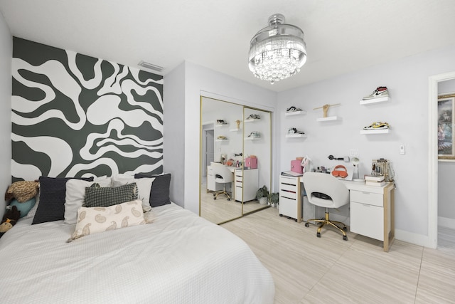 bedroom with a closet and a notable chandelier