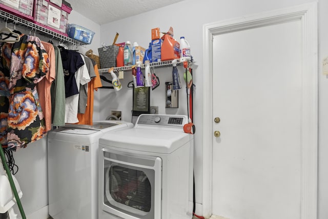 laundry area featuring a textured ceiling and separate washer and dryer