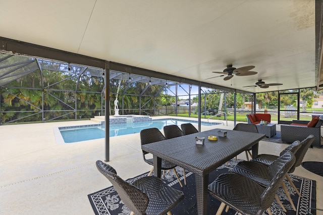 view of swimming pool with glass enclosure, ceiling fan, and a patio area