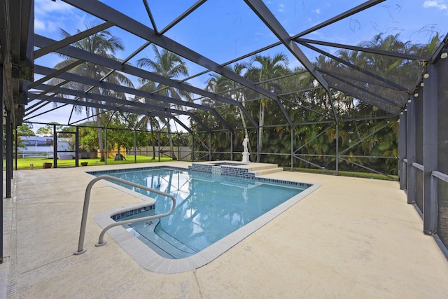 view of swimming pool featuring a lanai, an in ground hot tub, and a patio area