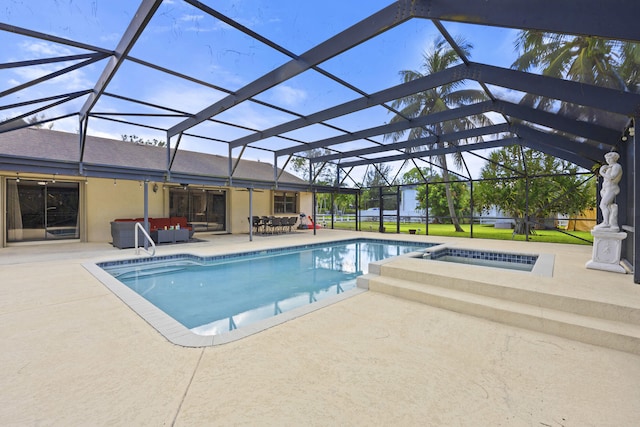 view of pool with a patio area, a lanai, and an in ground hot tub