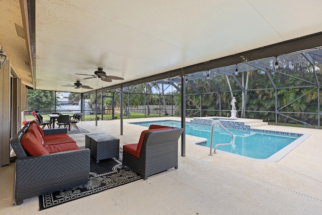 view of swimming pool with a lanai, ceiling fan, an in ground hot tub, and a patio area