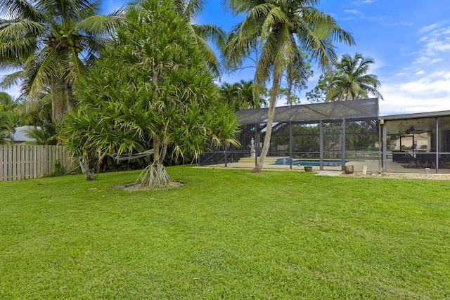 view of yard featuring a fenced in pool and a lanai