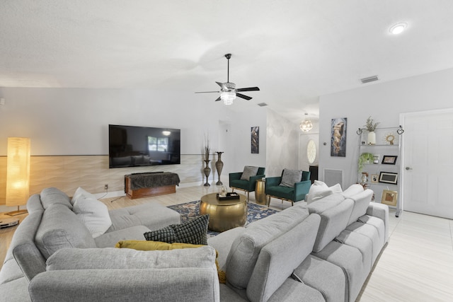 living room featuring light wood-type flooring and ceiling fan