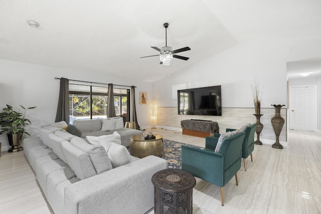 living room with ceiling fan and vaulted ceiling