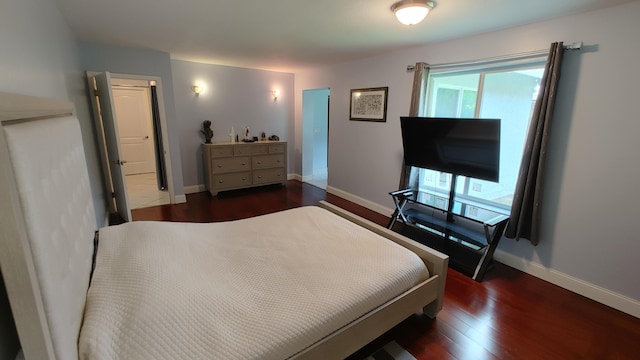 bedroom with dark hardwood / wood-style floors