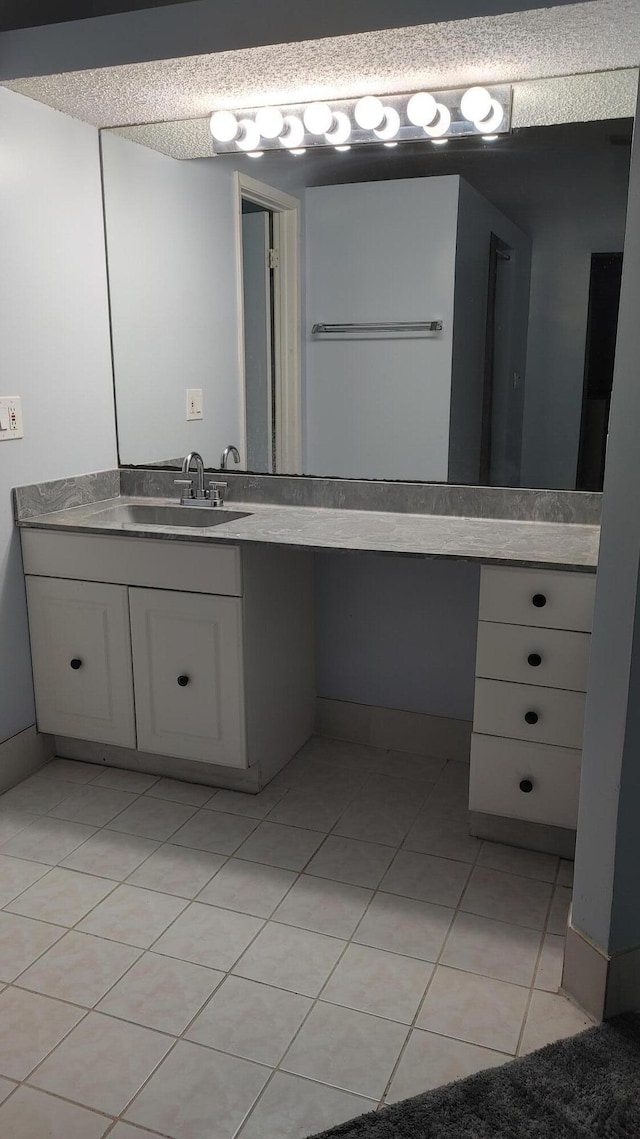 bathroom featuring vanity, tile patterned floors, and a textured ceiling