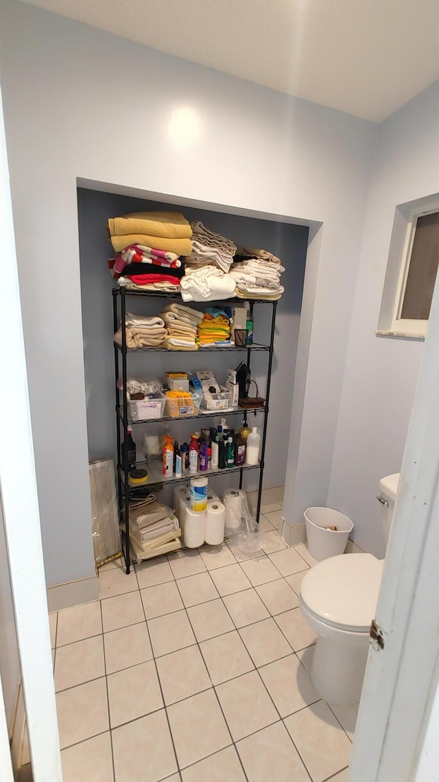 bathroom featuring toilet and tile patterned flooring