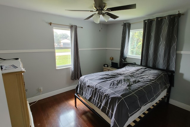 bedroom with dark wood-type flooring and ceiling fan