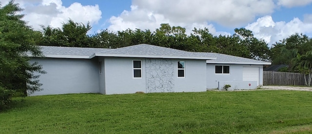 rear view of property featuring a yard