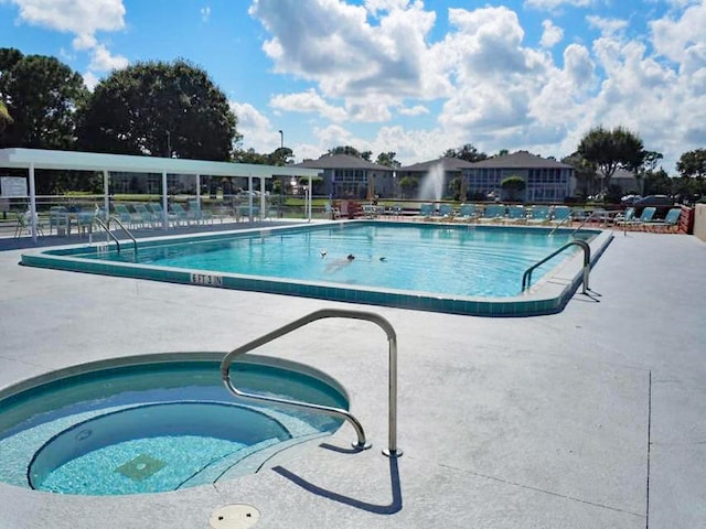 view of pool featuring a community hot tub and a patio area