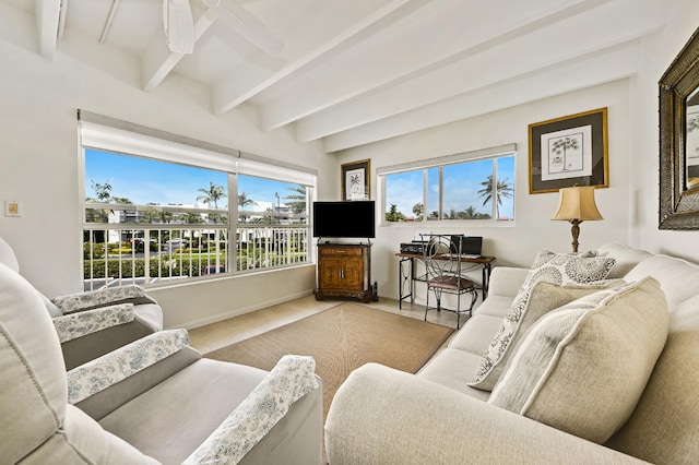 living room with ceiling fan, beamed ceiling, and carpet floors