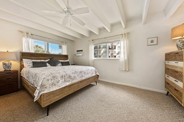 carpeted bedroom featuring multiple windows, beamed ceiling, and ceiling fan